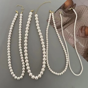 French style pearl necklace set with golden adjustable lobster clasps on grey backdrop