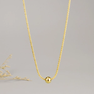 Minimalist gold titanium steel necklace featuring a polished round ball pendant on a star chain