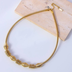 Collana minimalista in acciaio al titanio dorato con bobine geometriche e chiusura a moschettone