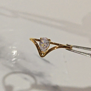 Elegant 18K gold plated V-shape ring featuring a sparkling pear cut cubic zirconia