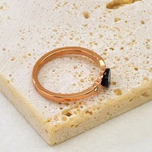 Elegant rose gold clover ring with black inlay and a small sparkling zircon stone