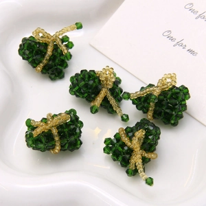 Detail view of 5 green crystal beaded rice dumplings with golden bows for DIY craft making