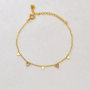 18K gold chain bracelet with geometric triangles and rhinestones on white surface