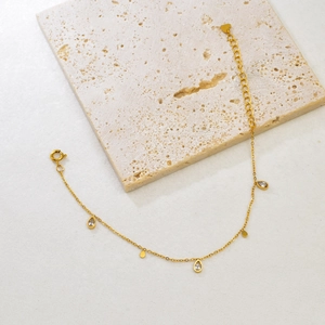Detail of 18K gold geometric bracelet with water drop crystals and lobster clasp closure