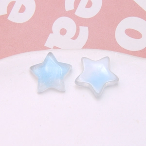 Macro detail of star-shaped resin charms with glitter gradient for DIY jewelry making