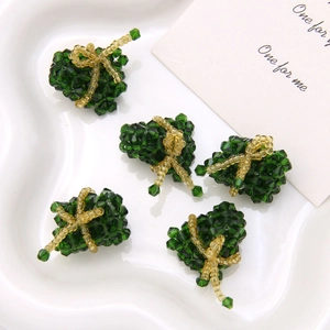 Macro shot of green crystal beaded gift box charms for DIY jewelry and earrings