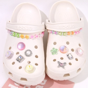 White clogs decorated with cute macaron star and heart charms and colorful bead chains