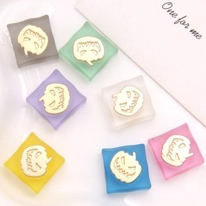 Detail view of colorful translucent frosted pumpkin charms for DIY jewelry crafting