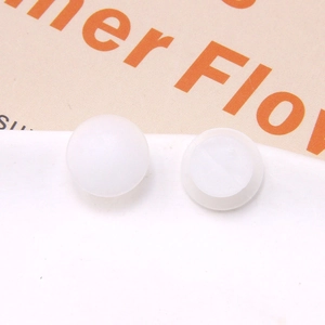 Macro detail of white plastic buckle bases for DIY beach clog shoe decorations