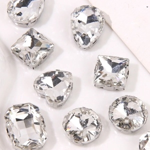 Macro detail of various faceted rhinestones with silver metal bases for DIY crafts