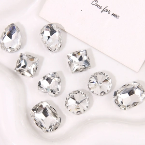 Macro shot of assorted faceted clear crystal charms with silver metal claw settings