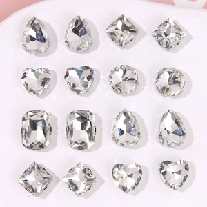 Assorted clear crystal charms in teardrop heart and square shapes with metal claw base