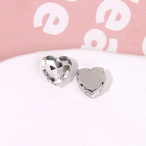 Macro shot of heart-shaped crystal rhinestone with silver metal base for DIY shoe charms
