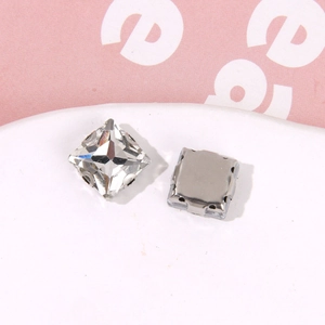 Macro view of square crystal glass rhinestones with silver metal claw base for DIY decor