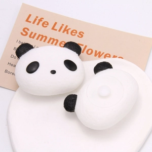 Detail of soft foam panda squishy charm showing front face and back attachment plug