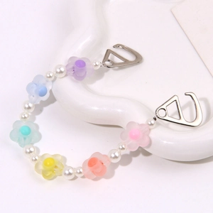 Dettaglio macro di fiori colorati opachi e perle bianche per accessori da calzature