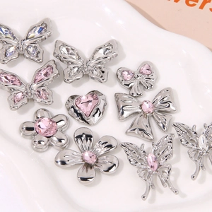 Detailed view of silver butterfly and heart charms with pink crystals for clog shoes