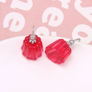 Detail of red translucent resin jelly pudding earrings with polished vertical stripes