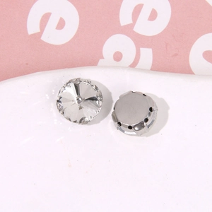 Close-up of faceted waterdrop rhinestones with silver metal claw bases for DIY crafts