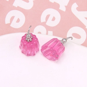 Macro shot of pink jelly pudding style resin earrings with silver metal hooks