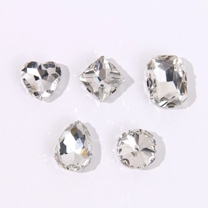 Macro view of crystal charms in various shapes with silver metal prong settings