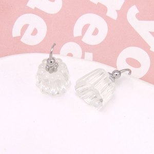 Detail of transparent jelly-style acrylic earrings with pleated texture and silver hooks