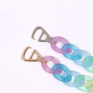 Macro detail of gradient rainbow acrylic chains with matte texture and metal alloy clasps