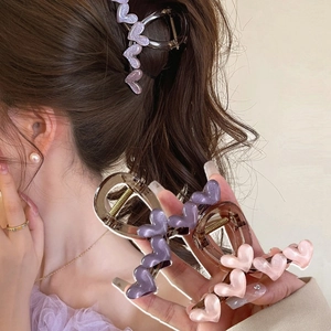 Pinze per capelli a cuore glitterate in viola perlato e rosa per lo styling di capelli lunghi