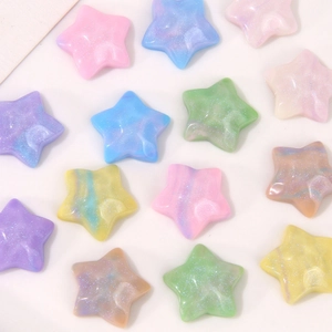Macro detail of star-shaped resin charms with glitter texture and pastel marble effect