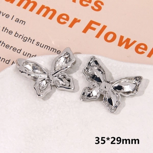 Detailed macro view of 35x29mm silver butterfly shoe charms with inlaid zircon stones