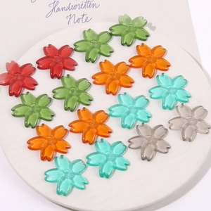 Translucent resin cherry blossom petals in various colors for DIY jewelry crafting