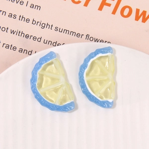 Detailed close-up of DIY resin lemon slice charms in yellow and blue for jewelry making