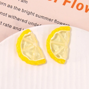 Detail of two handmade lemon slice resin charms with realistic fruit texture for DIY jewelry