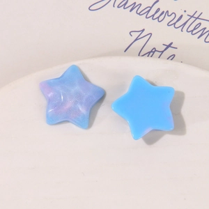 Macro view of blue glitter resin star charms for DIY earrings and hair accessories