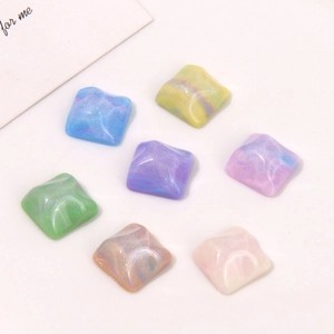 Macro view of square resin glitter cabochons with marble texture for DIY jewelry making