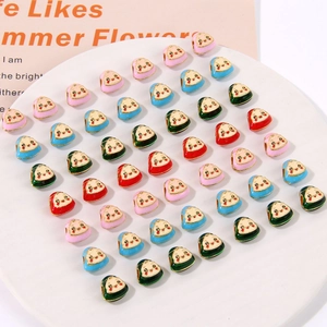 Detailed view of colorful enamel lucky charm beads with cute smiling faces for DIY jewelry