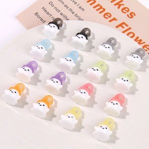 Flat lay of small resin ghost charms with colorful hats in a white tray for DIY crafts