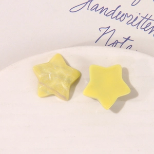 Detail of yellow star resin DIY accessories with silver glitter and matte finish