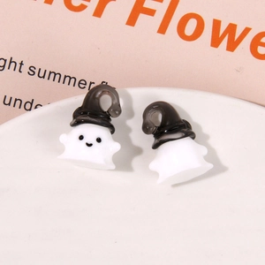 Macro shot of cute white resin ghost pendants with black hooks for DIY Halloween jewelry