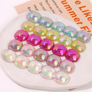 Macro detail of aurora gradient resin square charms with iridescent pearlescent finish
