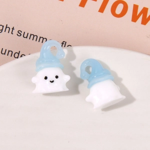 Detailed view of DIY resin ghost charms with blue sleeping hats and smiling faces