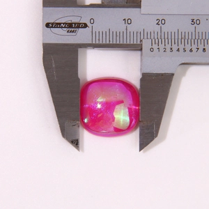 Close-up of measuring 15mm pearlescent rose red resin square charm with a digital caliper