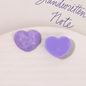 Détail macro de cœurs en résine violette avec paillettes et textures lisses pour DIY
