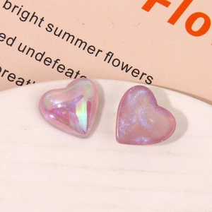 Macro detail of iridescent heart resin charms with glitter and pearlescent purple finish