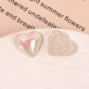 Macro shot of colorful pearlescent resin heart charms with aurora finish for DIY jewelry