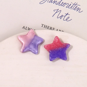 Macro shot of gradient pearlescent star charms for DIY crafts and accessories