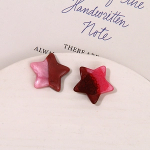 Macro view of pearlescent resin star charms with gradient glitter for DIY jewelry making