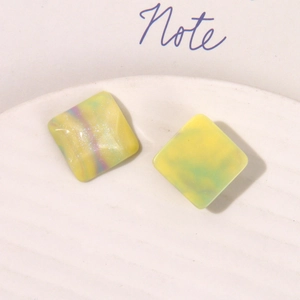 Square resin craft beads with yellow and purple marble pattern and glitter finish