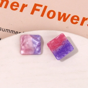 Macro shot of square pearlescent resin earrings with pink and purple marble texture