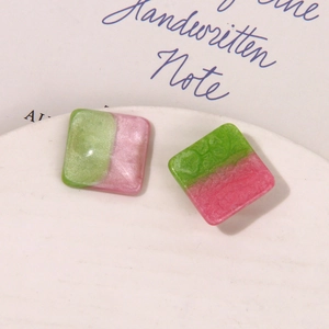 Detailed view of handmade square resin earrings with bicolor pearlescent finish and floral relief